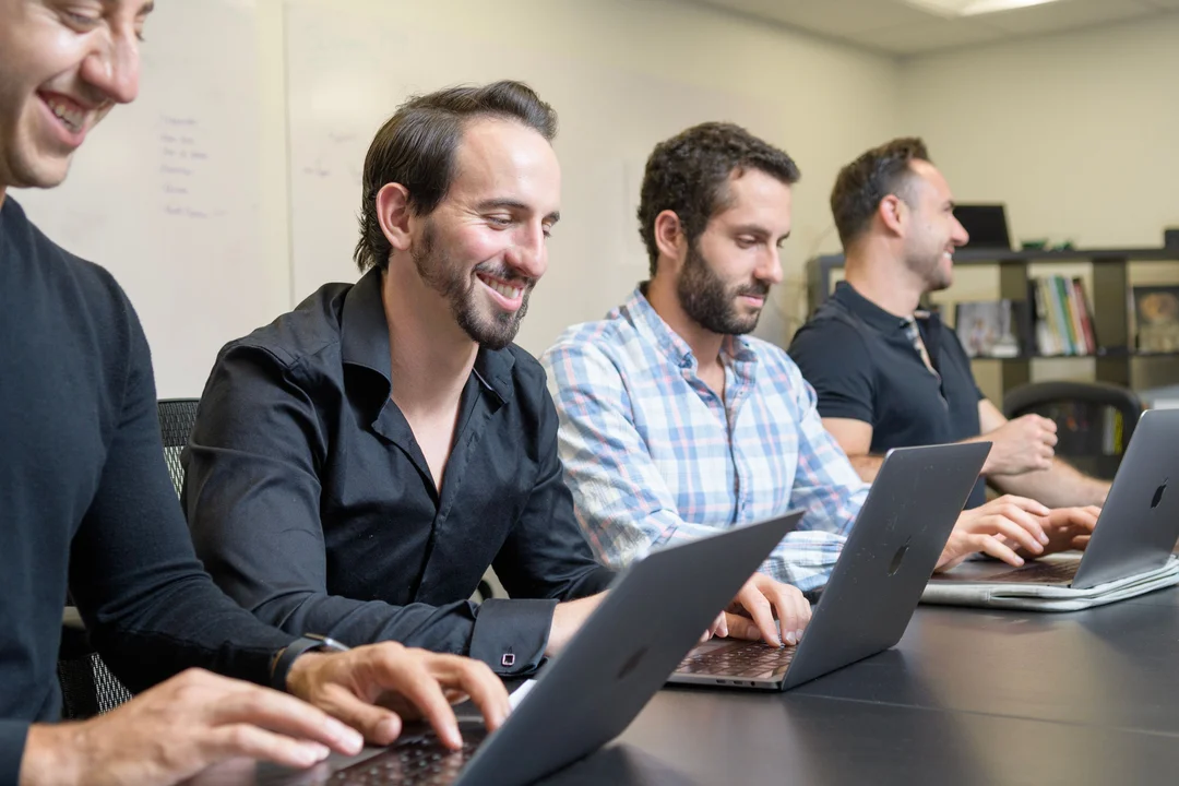 Ringba User Stories - Anthony Sarandrea Working with the Team on Laptops